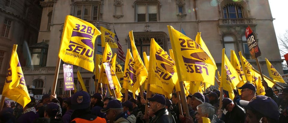 Members of the Service Employees International Union (SEIU) march during a protest in support of a new contract for apartment building workers in New York City