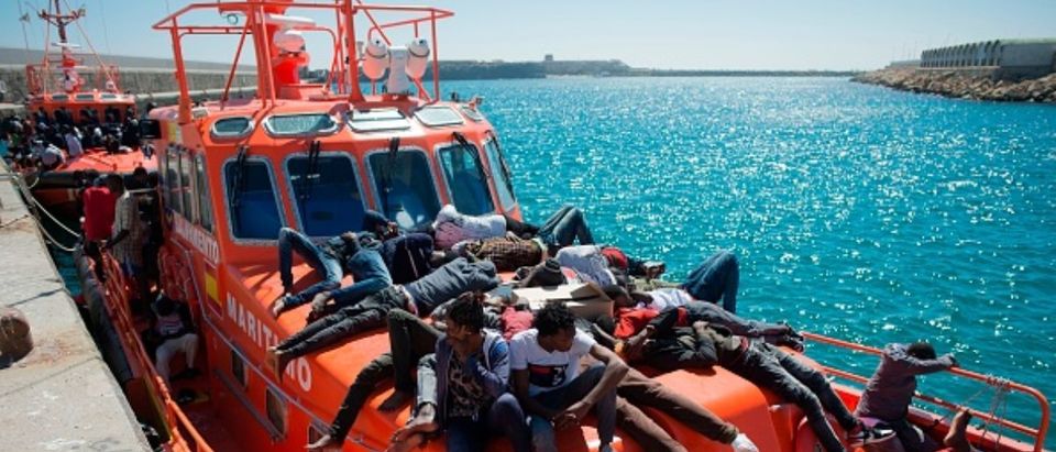 Migrants wait to be transferred after arriving aboard a coast guard boat at the harbour in Tarifa on July 26, 2018 after their inflatable boat was rescued by the Spanish coast guard in the Mediterranean Sea.(JORGE GUERRERO/AFP/Getty Images)