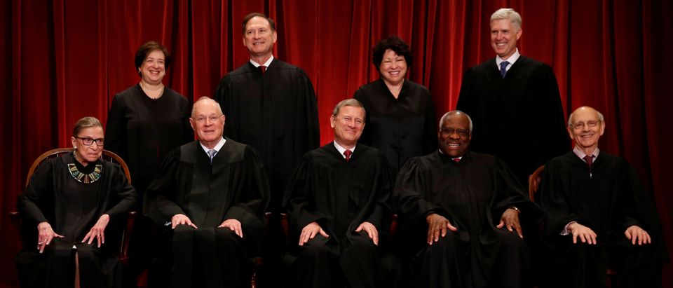 Roberts leads the U.S. Supreme Court in taking a new family photo including Gorsuch, their most recent addition, at the Supreme Court building in Washington