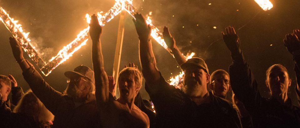 Supporters of the National Socialist Movement give Nazi salutes while taking part in a swastika burningin Georgia, United States