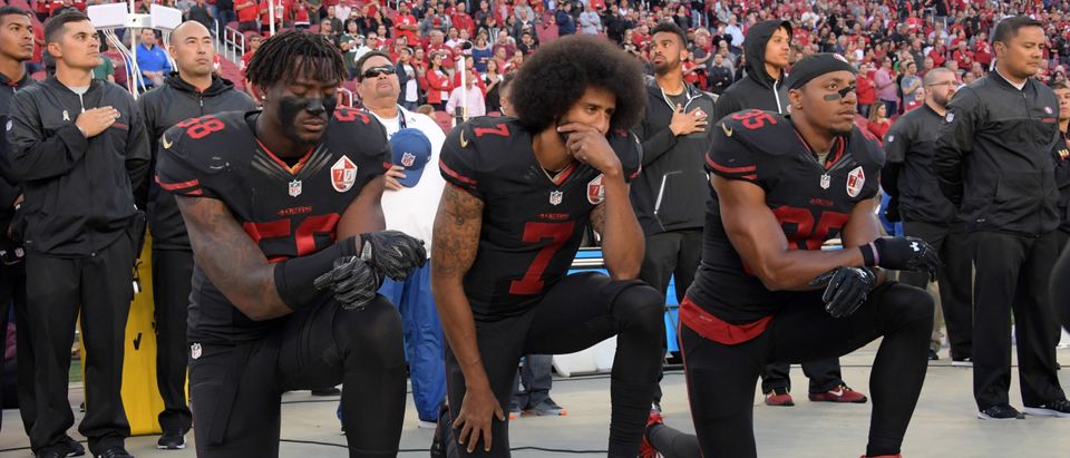 Oct 6, 2016; Santa Clara, CA, USA; San Francisco 49ers outside linebacker Eli Harold (58), quarterback Colin Kaepernick (7) and free safety Eric Reid (35) kneel in protest during the playing of the national anthem before a NFL game against the Arizona Cardinals at Levi's Stadium. Mandatory Credit: Kirby Lee-USA TODAY Sports