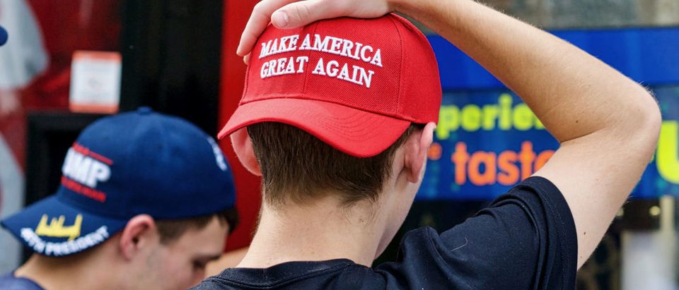 Washington, DC - October 6, 2017: Two unidentified men display their support for President Donald J. Trump through the hats they are wearing during a visit to the National Zoo. SHUTTERSTOCK/ John Chase