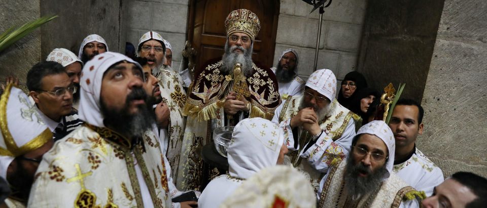 Archbishop Anba Antonius, Coptic Orthodox Metropolitan of Jerusalem and the Near East, participates in a Palm Sunday procession in the Church of the Holy Sepulchre in Jerusalem's Old City, April 1, 2018. REUTERS/Ammar Awad