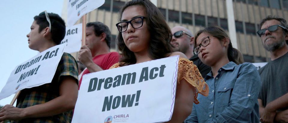 Alejandra Garcia, center, stands with supporters of the Deferred Action for Childhood Arrivals program during a rally outside the Edward R. Roybal Federal Building in Los Angeles, California