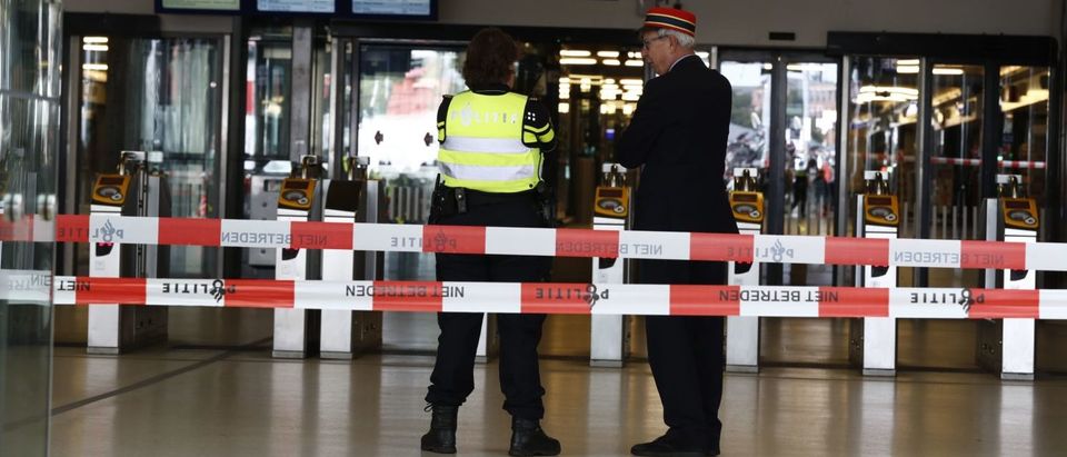 Officials stand inside a cordonned-off area at The Central Railway Station in Amsterdam on August 31, 2018, after two people were injured in a stabbing incident. - Two people were hurt during a stabbing incident at Amsterdam's busy Central Station with the alleged attacker shot and wounded, Dutch police said. (REMKO DE WAAL/AFP/Getty Images)