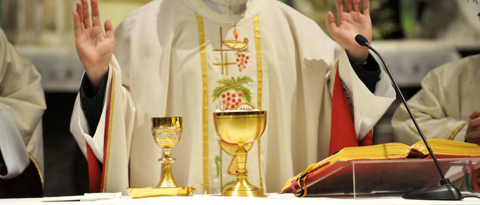 A Priest Saying Mass (Shutterstock/ peacepix)