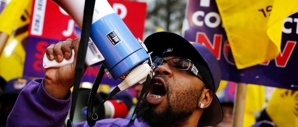 Members of the Service Employees International Union (SEIU) chant slogans during a protest in support of a new contract for apartment building workers in New York City