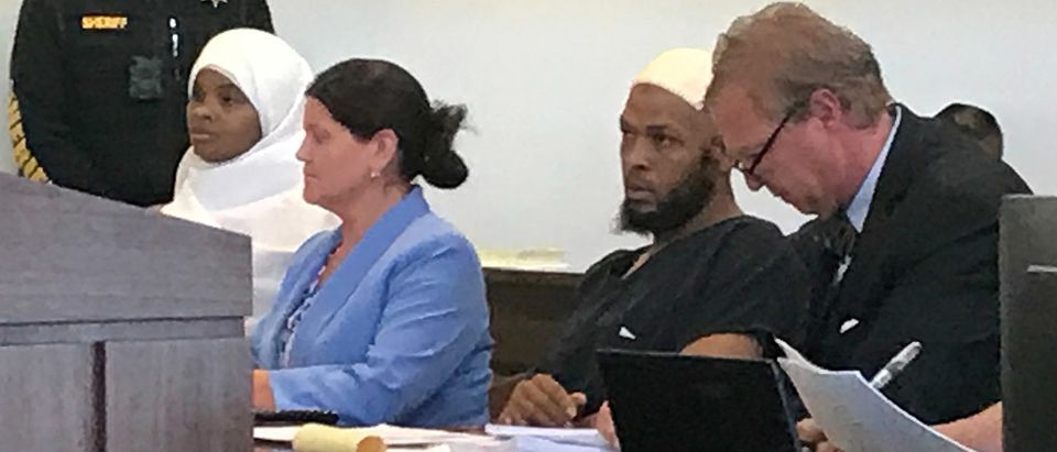 Defense attorney Thomas Clark sits next to his client, defendant Siraj Ibn Wahhaj, defense attorney Marie Legrand Miller and her client Hujrah Wahhaj during a hearing on charges of child abuse in which they were granted bail in Taos County