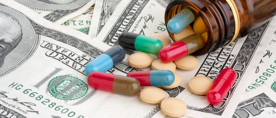 Pills and American dollars , Shutterstock/ By mariocigic