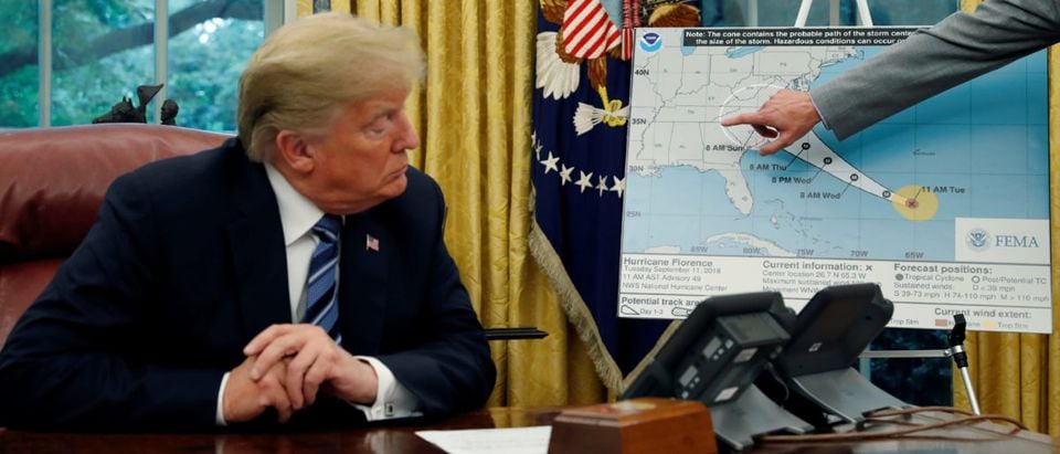 FILE PHOTO: U.S. President Donald Trump holds an Oval Office meeting on hurricane preparations as FEMA Administrator Brock Long points to the potential track of Hurricane Florence on a graphic at the White House in Washington, U.S., September 11, 2018. REUTERS/Leah Millis/File Photo
