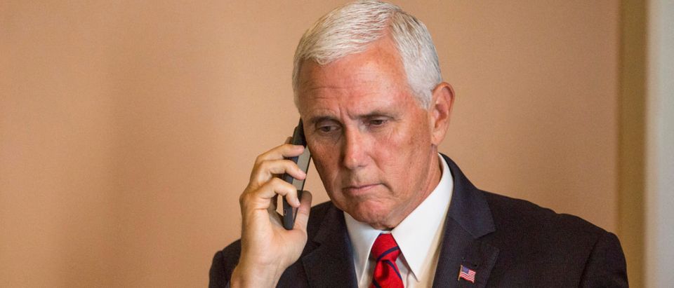 U.S. Vice President Mike Pence takes a phone call on Capitol Hill following a mock swear-in ceremony for U.S. Sen. John Kyl (R-AZ) on September 5, 2018 in Washington, DC. The former senator Kyl was tapped by Arizona Gov. Doug Ducey to replace the late Sen. John McCain. Photo by Zach Gibson/Getty Images