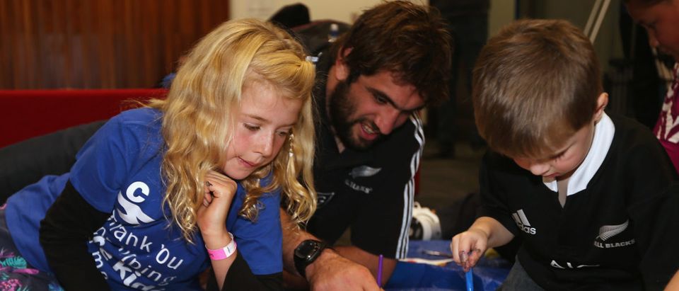 Alana Blow (L) who lives with ADHD and Marfan syndrome paints alongside All Black Sam Whitelock (R) during the New Zealand All Blacks 'Cure Kids' Appearance at Auckland University on June 2, 2014 in Auckland, New Zealand. Sandra Mu/Getty Images for Cure Kids