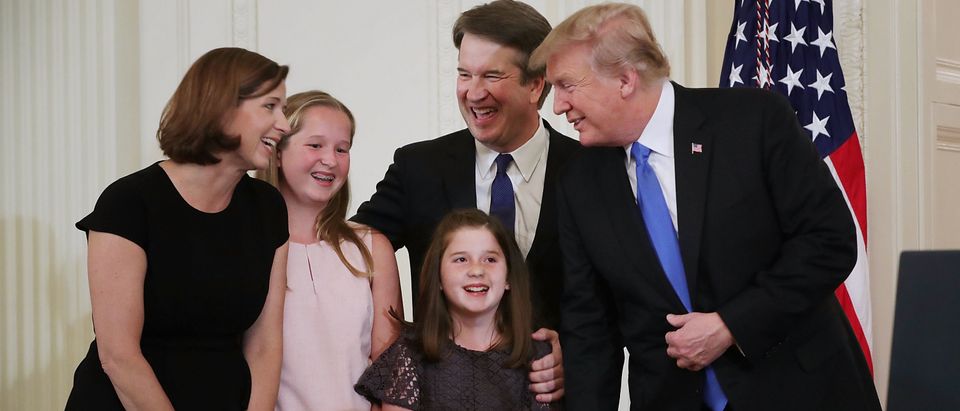 President Donald Trump, Judge Brett M. Kavanaugh, his wife Ashley Estes Kavanaugh and their daughters, Margaret and Liza, share a laugh after Trump announced the judge as his nominee to the United States Supreme Court during an event in the East Room of the White House July 9, 2018 in Washington, D.C. (Photo by Chip Somodevilla/Getty Images)