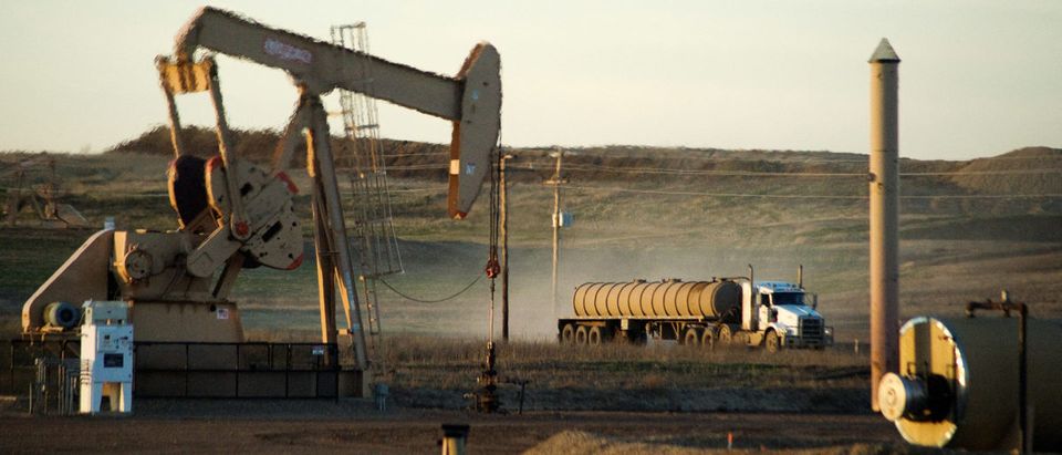 FILE PHOTO: A service truck drives past an oil well on the Fort Berthold Indian Reservation in North Dakota