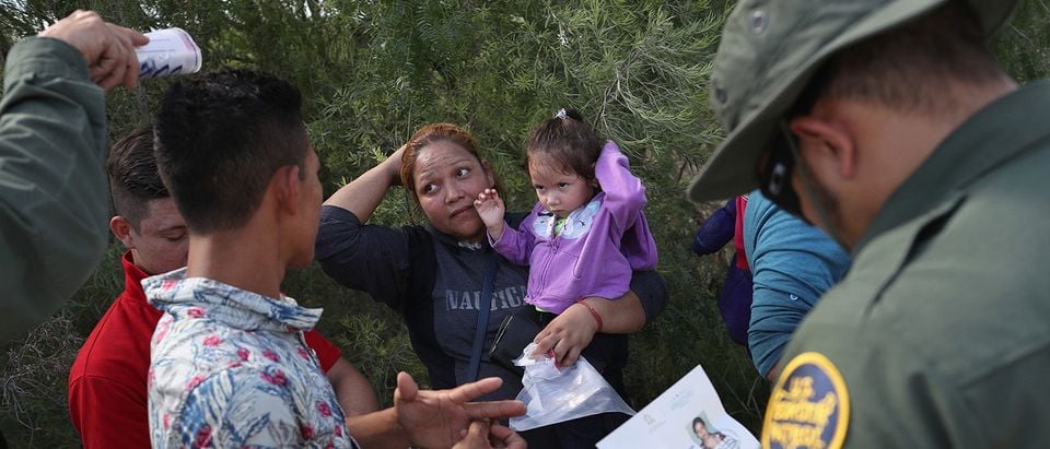 U.S. Border Patrol agents ask a group of Central American asylum seekers to remove hair bands and weddding rings before taking them into custody on June 12, 2018 near McAllen, Texas. The immigrant families were then sent to a U.S. Customs and Border Protection (CBP) processing center for possible separation. U.S. border authorities are executing the Trump administration's "zero tolerance" policy towards undocumented immigrants. U.S. Attorney General Jeff Sessions also said that domestic and gang violence in immigrants' country of origin would no longer qualify them for political asylum status. (Photo by John Moore/Getty Images)