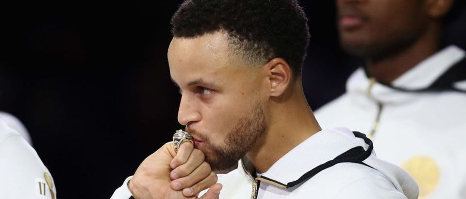 Stephen Curry #30 of the Golden State Warriors kisses his 2017-2018 Championship ring prior to their game against the Oklahoma City Thunder at ORACLE Arena on October 16, 2018 in Oakland, California. NOTE TO USER: User expressly acknowledges and agrees that, by downloading and or using this photograph, User is consenting to the terms and conditions of the Getty Images License Agreement. (Photo by Ezra Shaw/Getty Images)
