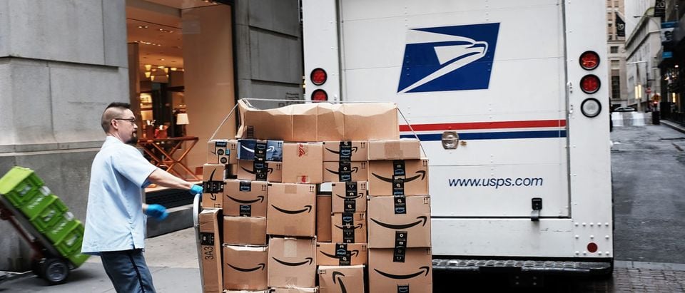 A U.S. Postal worker delivers Amazon boxes outside of the New York Stock Exchange (NYSE) on October 11, 2018 in New York City. Spencer Platt/Getty Images