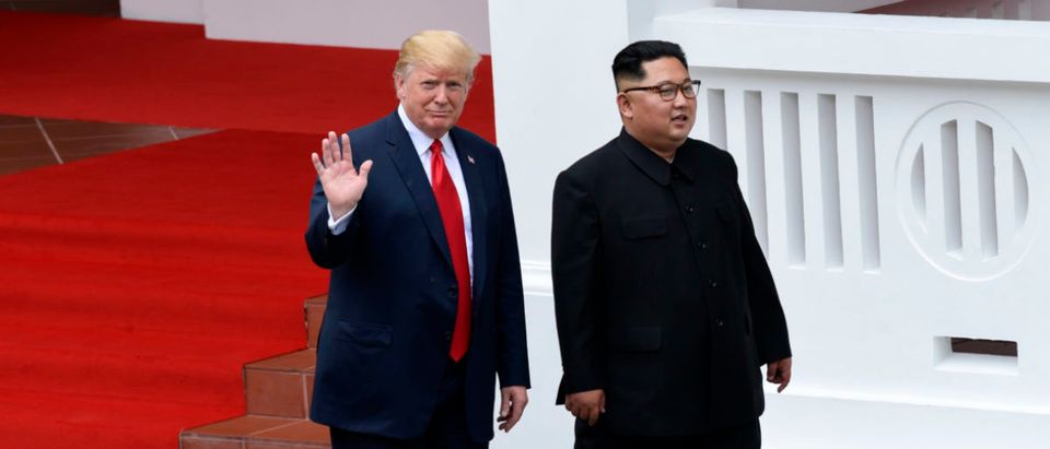 North Korea's leader Kim Jong Un (R) walks with US President Donald Trump (L) after lunch and during a break in talks at their historic US-North Korea summit, at the Capella Hotel on Sentosa island in Singapore on June 12, 2018. - Donald Trump and Kim Jong Un became on June 12 the first sitting US and North Korean leaders to meet, shake hands and negotiate to end a decades-old nuclear stand-off. (Photo by Susan Walsh / POOL / AFP) (Photo credit should read SUSAN WALSH/AFP/Getty Images)
