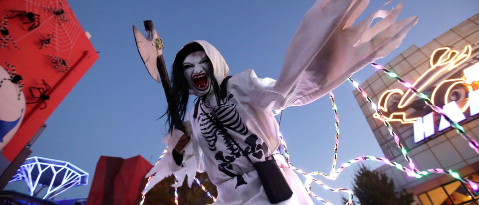 A participant in costume poses for a photo during a Halloween event in Beijing