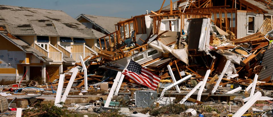 An American flag flies amongst rubble left in the aftermath of Hurricane Michael in Mexico Beach