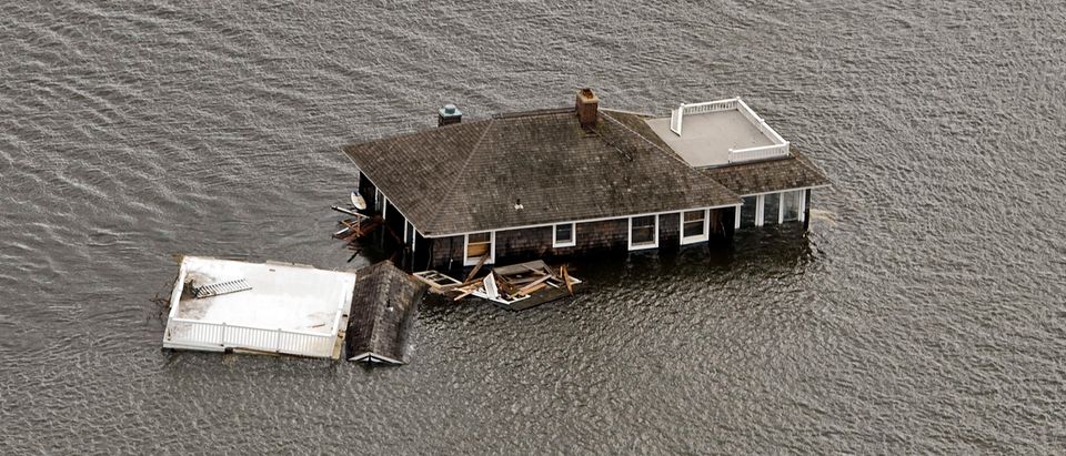 A house floats in the bay after it was washed from its foundation during Hurricane Sandy in Manotoloking
