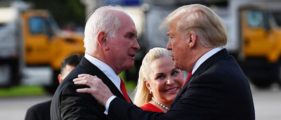 US President Donald Trump greets Rep. Mike Kelly and his wife Victoria upon arrival at Erie International Airport in Erie, Pennsylvania on October 10, 2018. (Photo by MANDEL NGAN / AFP) (Photo credit should read MANDEL NGAN/AFP/Getty Images)