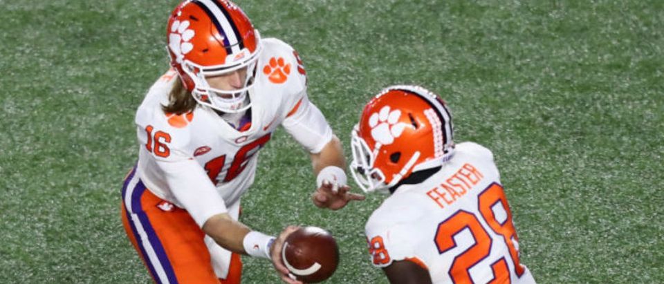 CHESTNUT HILL, MA - NOVEMBER 10: Quarterback Trevor Lawrence #16 of the Clemson Tigers hands off to Tavien Feaster #28 of the Clemson Tigers during the third quarter of the game against the Boston College Eagles at Alumni Stadium on November 10, 2018 in Chestnut Hill, Massachusetts. (Photo by Omar Rawlings/Getty Images)
