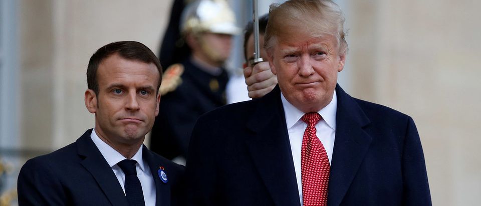 French President Emmanuel Macron welcomes US President Donald Trump as he arrives at the Elysee Palace in Paris