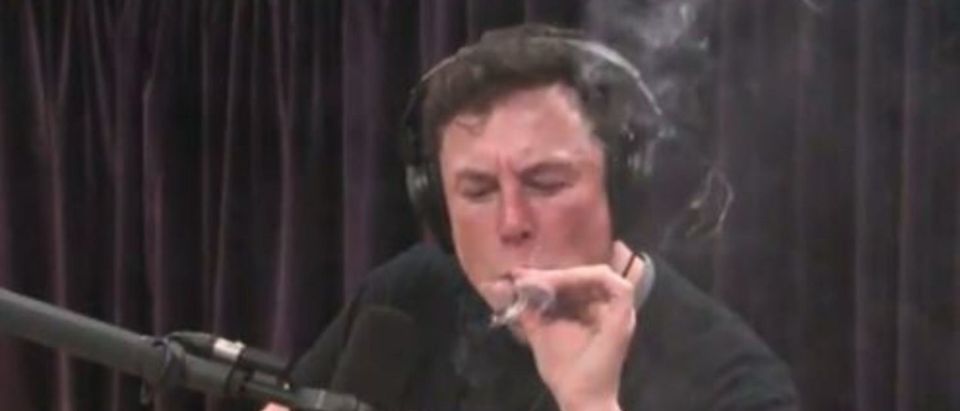 Elon Musk takes a drag off a marijuana cigarette during Joe Rogan's podcast (snapshot of YouTube)