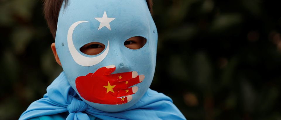 An ethnic Uighur boy living in Turkey, takes part in a protest against China, in Istanbul, Turkey Nov. 6, 2018. REUTERS/Murad Sezer