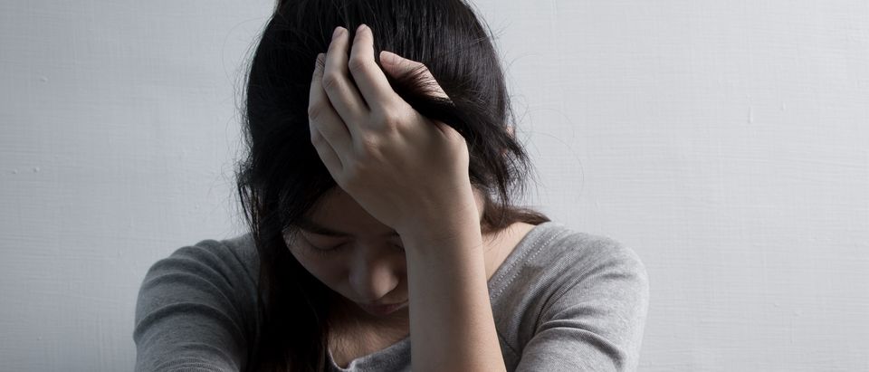A woman grapples with depression. Shutterstock image via user aslysun