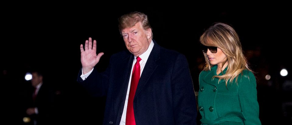 U.S. President Donald Trump and First Lady Melania Trump make their way across the South Lawn of the White House after returning on Marine One from their surprise trip to Al Asad Air Base in Iraq to visit troops, in Washington, DC, USA, 27 December 2018. (Photo by Pete Marovich - Pool/Getty Images)