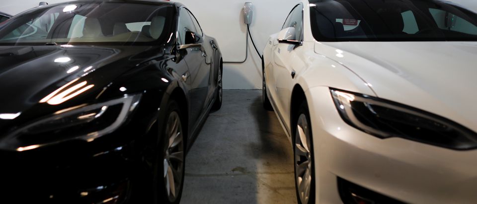 Tesla Model 3s are shown charging in an underground parking lot next to a Tesla store in San Diego,California
