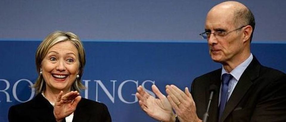 WASHINGTON - MAY 27: U.S. Secretary of State Hillary Clinton (L) is applauded by Brookings Institution President Strobe Talbott before she delivers remarks about the Obama administration's national security strategy at the Brookings Institution May 27, 2010 in Washington, DC. Clinton addressed a variety of security topics, including the prevention of nuclear proliferation, terrorism, the use of military force, development and diplomacy. (Photo by Chip Somodevilla/Getty Images)