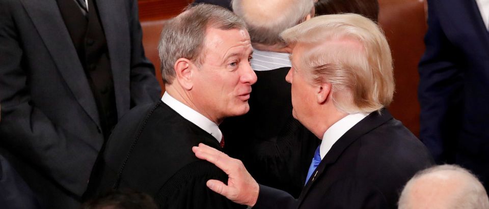 President Donald Trump talks with Chief Justice John Roberts as he departs after delivering his State of the Union address to a joint session of the U.S. Congress on Capitol Hill Jan. 30, 2018. REUTERS/Jonathan Ernst