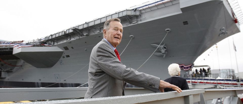 Former president George H. W. Bush walks the gangway as he arrives for the christening ceremony of the USS George H.W. Bush at Northrop-Grumman's shipyard in Newport News, Virginia, October 7, 2006. The Navy's Nimitz-class aircraft carrier is scheduled to enter service in late 2008. REUTERS/Kevin Lamarque