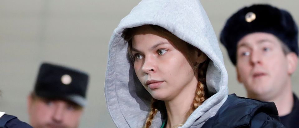 Model Vashukevich is escorted before a court hearing in Moscow
