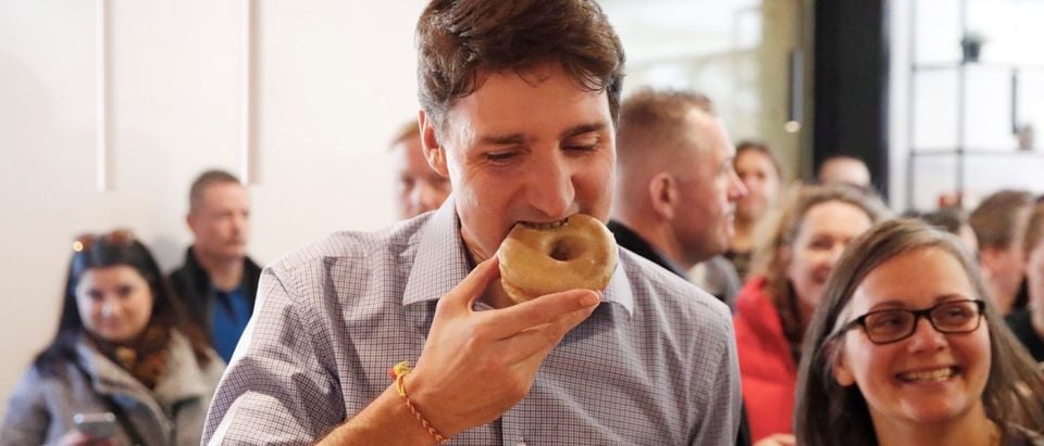 Canada's PM Trudeau eats a donut at the Donut Monster shop in Hamilton