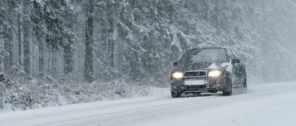 A car is pictured driving in snow. (Shutterstock/Olaf Naami)