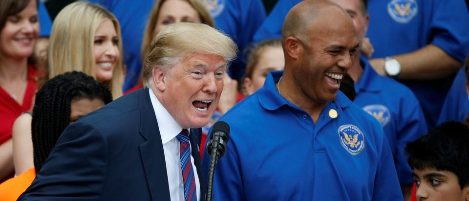 U.S. President Donald Trump laughs with former New York Yankees pitcher Mariano Rivera as he delivers remarks at the White House Sports and Fitness Day event on the South Lawn of the White House in Washington, U.S., May 30, 2018. REUTERS/Leah Millis