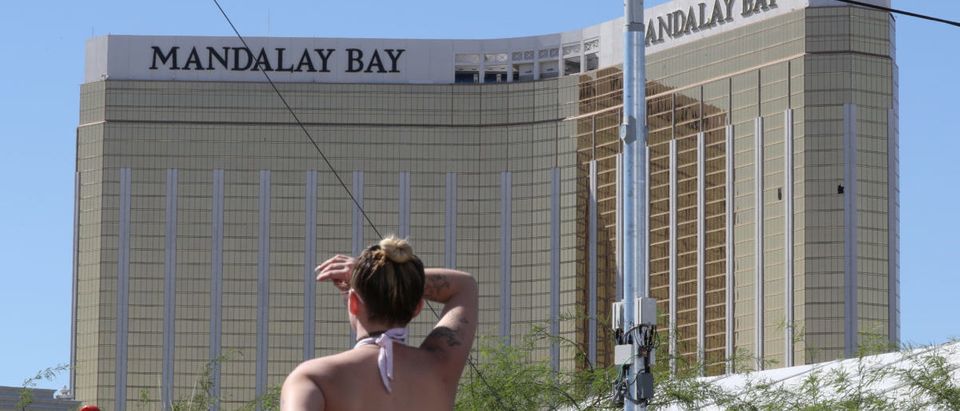A lady stands by police crime scene tape and looks towards the Mandalay Bay Resort and Casino, near the scene of a mass shooting at the Route 91 Festival in Las Vegas, Nevada, U.S., October 2, 2017. REUTERS/Lucy Nicholson