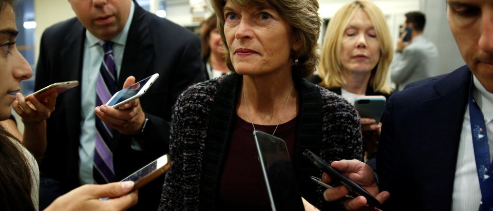 Sen. Lisa Murkowski speaks to journalists as she arrives for a vote on Capitol Hill in Washington, U.S., Sept. 24, 2018. REUTERS/Joshua Roberts