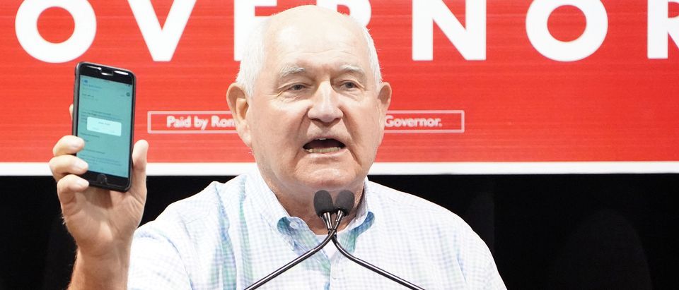 United States Secretary of Agriculture Sonny Perdue holds up a phone as he attends a rally for candidate for governor Ron DeSantis in Lakeland,