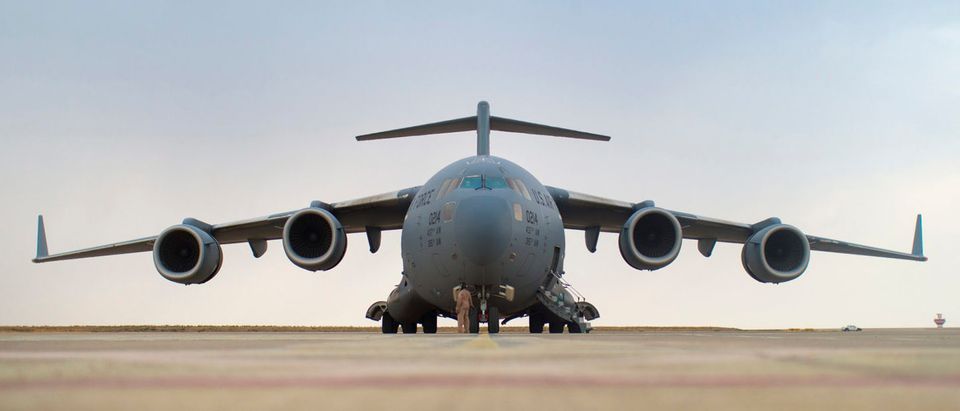 A crew member checks a U.S. Air Force C-17 at the airport in Irbil, Iraq