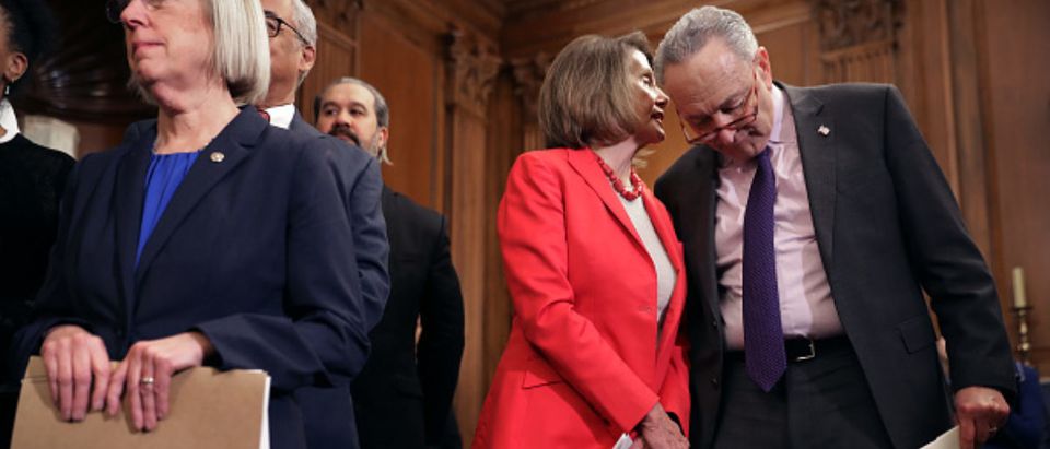 Schumer and Pelosi talk during an event to introduce the Raise The Wage Act -- Chip Somodevilla - Getty Images