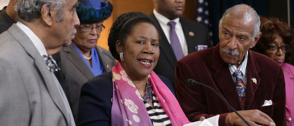 Rep. Sheila Jackson Lee at a press conference calling for a Senate vote on Loretta Lynch's Attorney General nomination. To the right is former Rep. John Conyers, who resigned in disgrace after female staffers accused him of sexual harassment. (Win McNamee/Getty Images)