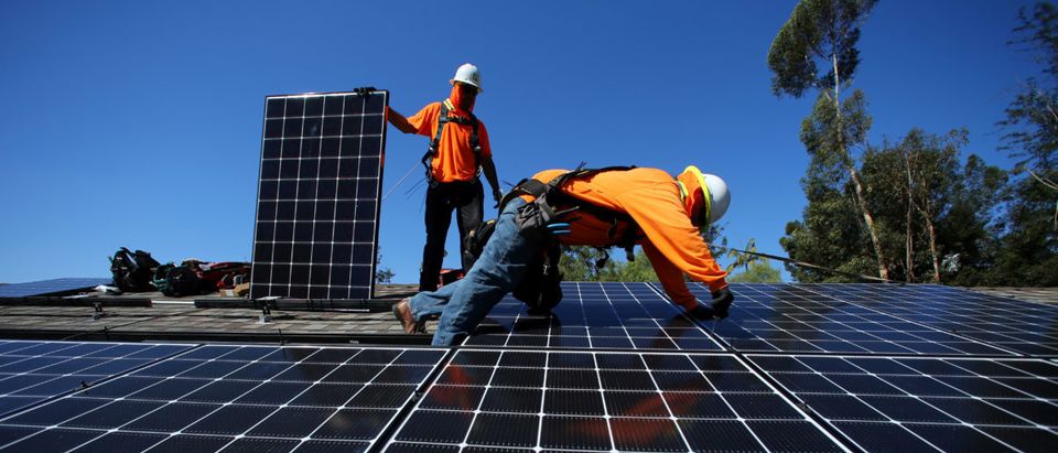 Solar installers from Baker Electric place solar panels on the roof of a residential home in Scripps Ranch, San Diego, California, U.S. October 14, 2016. REUTERS/Mike Blake