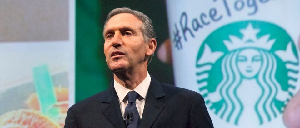 Starbucks Corp Chief Executive Howard Schultz, pictured with images from the company's new "Race Together" project behind him, speaks during the company's annual shareholder's meeting in Seattle, Washington March 18, 2015. REUTERS/David Ryder
