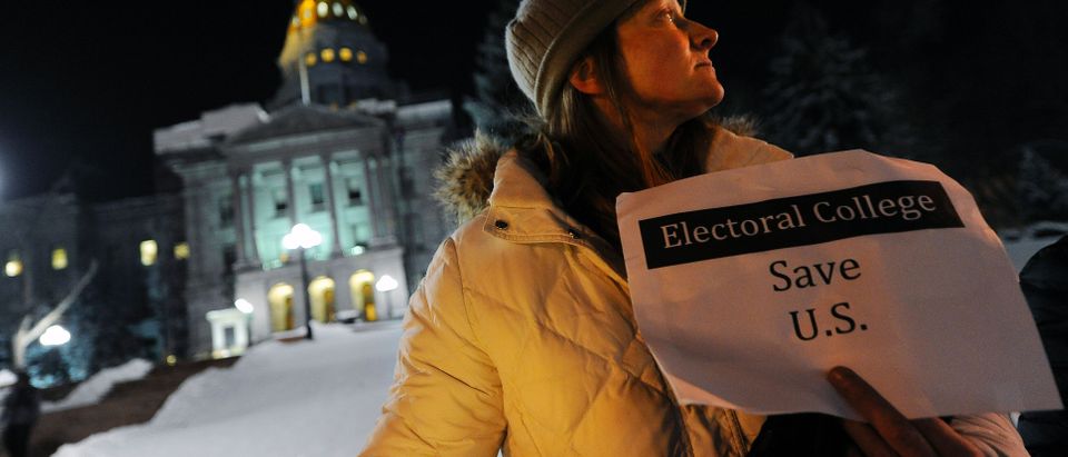 Ruth Fulton, 44, demonstrates during a candlelight vigil against US President-elect Donald Trump outside the Colorado Capitol building on the eve of the Electoral College vote, in Denver, Colorado on December 18, 2016. "The Electoral College is supposed to be a safeguard against exactly this sort of person," said Fulton. CHRIS SCHNEIDER/AFP/Getty Images