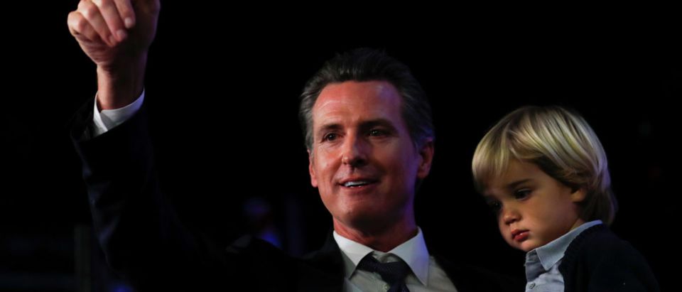 California Democratic gubernatorial candidate Gavin Newsom celebrates with his youngest son Dutch after being elected governor of the state during an election night party in Los Angeles, California, U.S., Nov. 6, 2018. REUTERS/Mike Blake